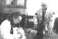 1990. 70th jubilee of the Museum. Manushina T.N.  signing her book for M.D. Glinkin.
